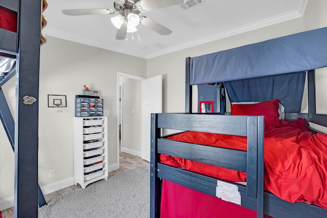 bedroom featuring hardwood / wood-style floors, ceiling fan, and ornamental molding