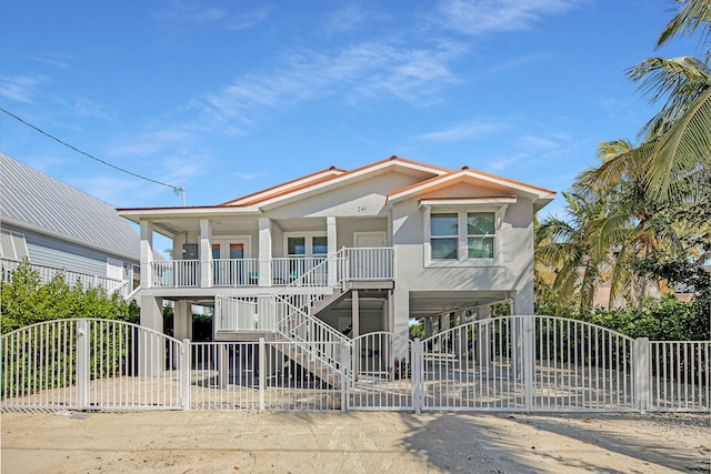 coastal inspired home with a carport and a porch