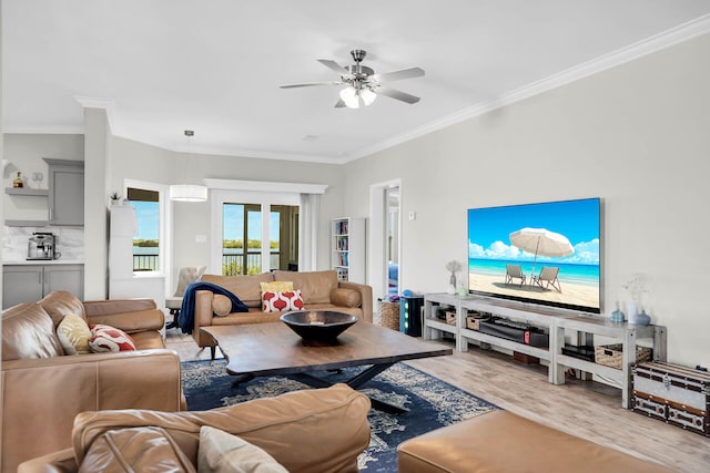 living room with ornamental molding, hardwood / wood-style floors, and ceiling fan