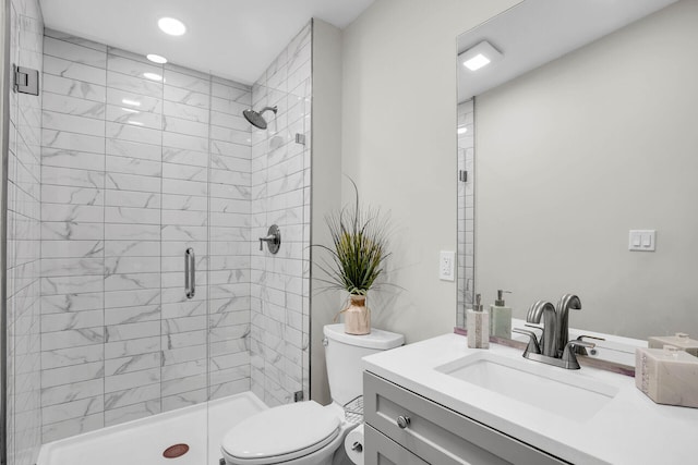 bathroom featuring toilet, vanity, and an enclosed shower