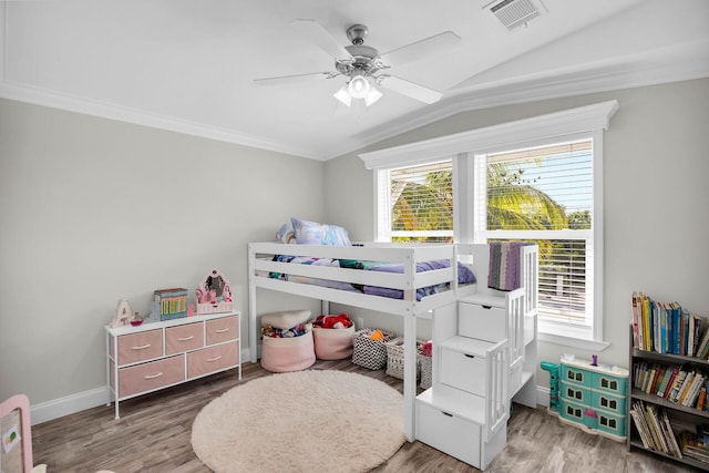 bedroom featuring crown molding, lofted ceiling, wood-type flooring, and ceiling fan