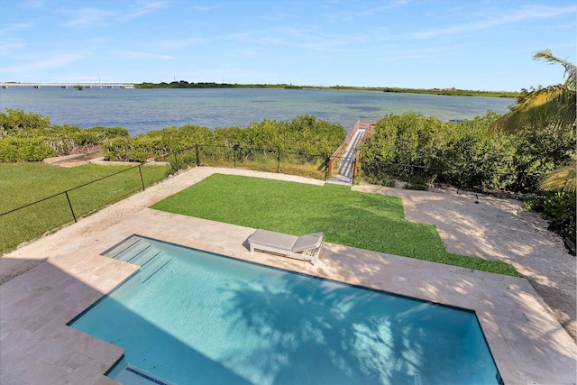 view of swimming pool with a water view, a patio, and a lawn