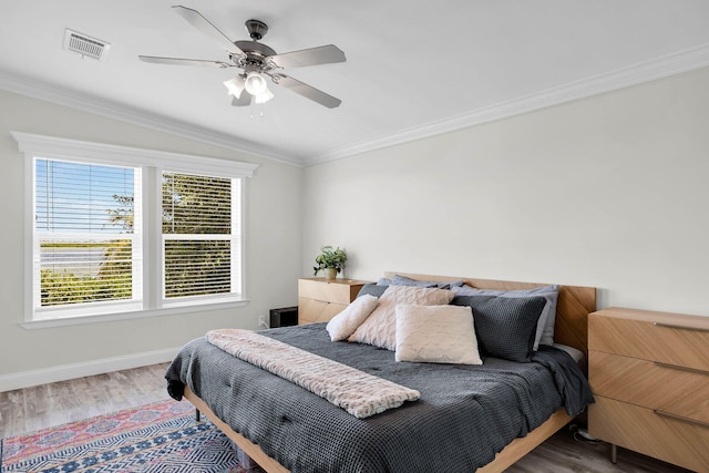 bedroom featuring crown molding, ceiling fan, and wood-type flooring