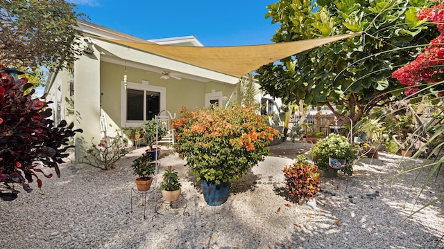 exterior space with fence, a ceiling fan, and a patio