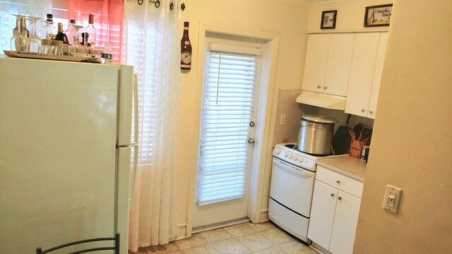 kitchen featuring white cabinetry and white appliances