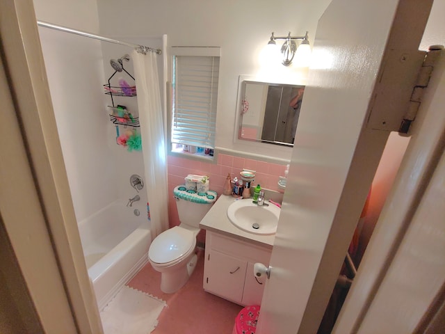 full bathroom featuring vanity, toilet, shower / tub combo, and tile walls