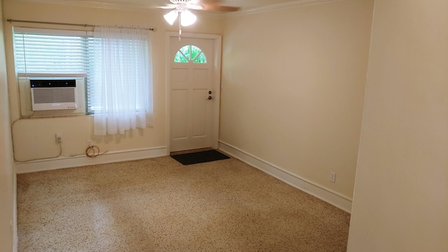 foyer entrance with crown molding, cooling unit, and ceiling fan