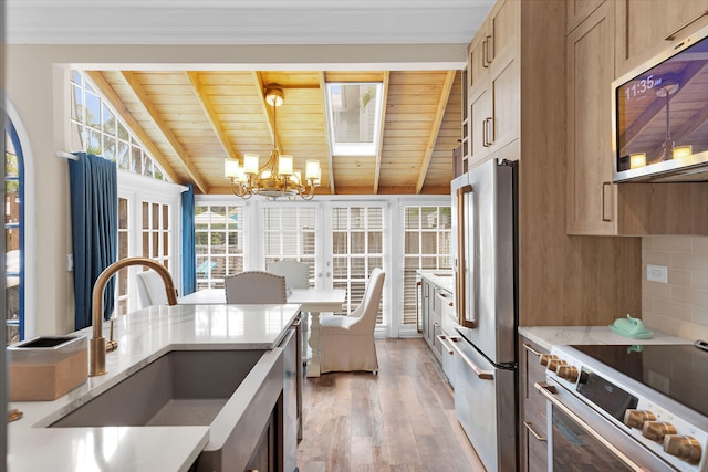 1001 United St Unit B, Key West, FL 33040 - kitchen featuring stainless steel appliances, wood ceiling, light wood-style flooring, a chandelier, and light stone countertops