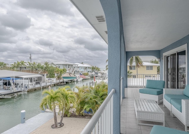 balcony featuring a residential view, an outdoor living space, a water view, and visible vents