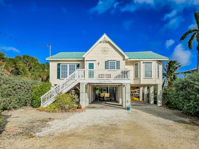 raised beach house featuring a carport