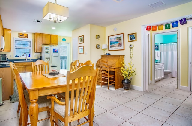 dining area with light tile patterned flooring and sink