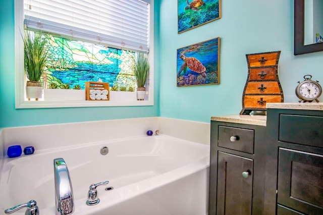 bathroom with a tub to relax in and a wealth of natural light