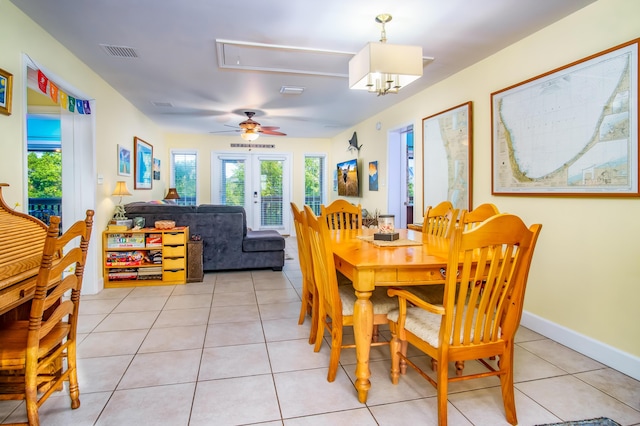 dining area featuring light tile patterned flooring, french doors, and a wealth of natural light