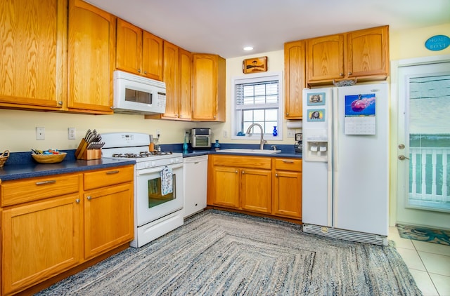 kitchen featuring light tile patterned flooring, sink, and white appliances