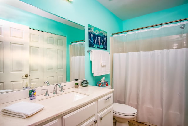 bathroom featuring vanity, a shower with curtain, and toilet