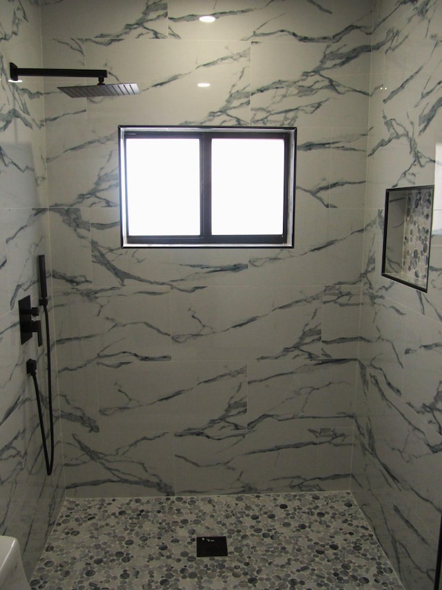 bathroom with a tile shower