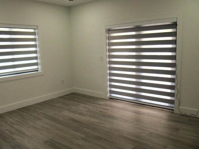 empty room with dark wood-type flooring