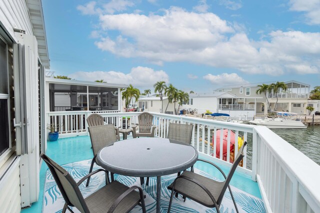 balcony featuring a deck with water view