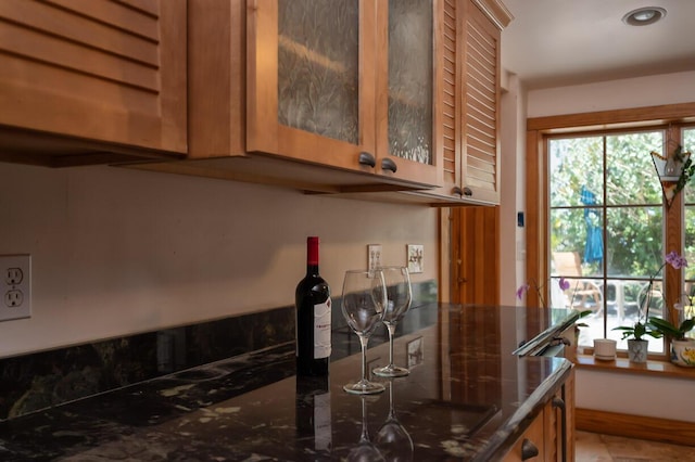 bar featuring dark stone counters