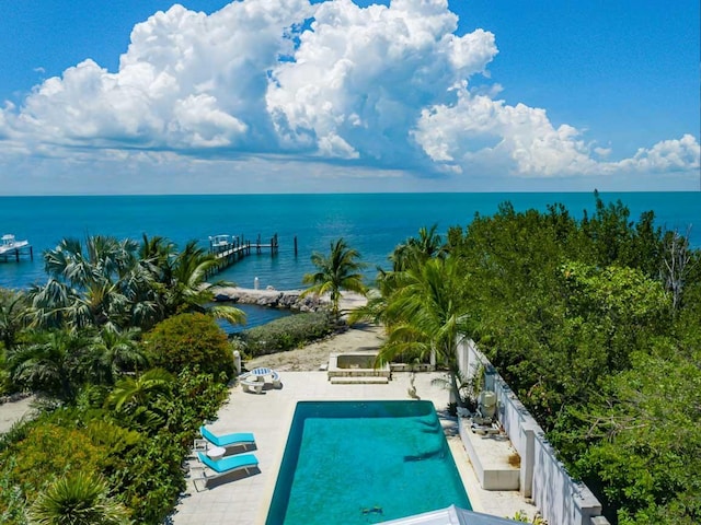 view of pool with a water view and a patio area