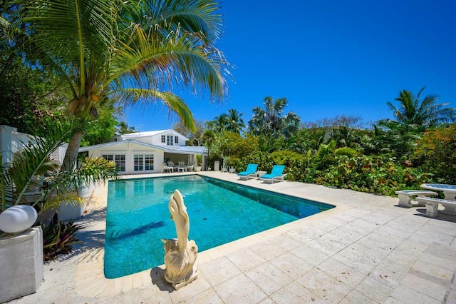 view of swimming pool featuring an outbuilding and a patio area