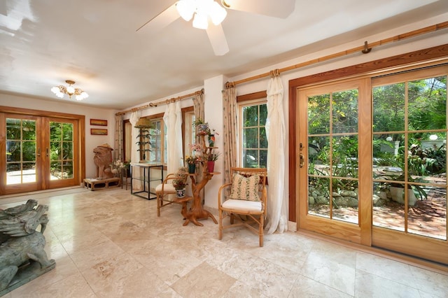 living area featuring ceiling fan and french doors