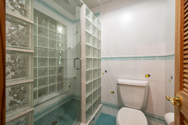 bathroom featuring toilet, tile walls, and walk in shower