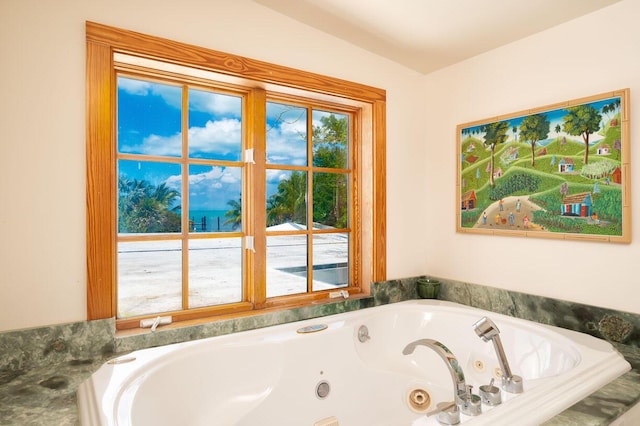 bathroom featuring tiled tub