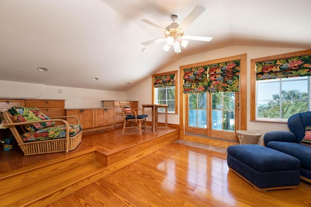 living area with vaulted ceiling and light wood-type flooring