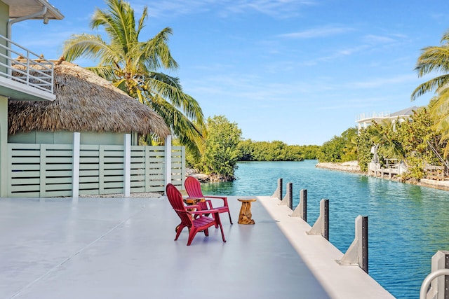 dock area with a water view and a patio area