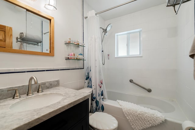 full bathroom with shower / tub combo with curtain, vanity, toilet, and tile walls