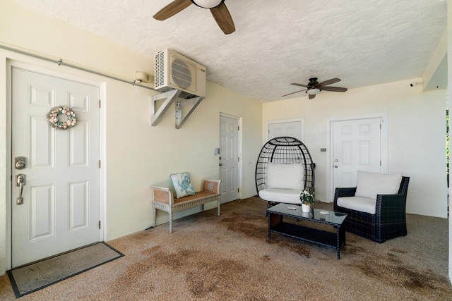 interior space with ceiling fan, carpet, and a textured ceiling