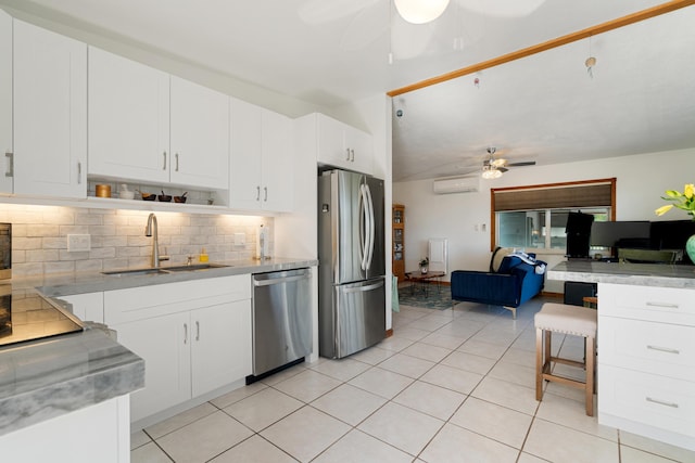 kitchen with sink, a wall mounted AC, white cabinets, ceiling fan, and stainless steel appliances