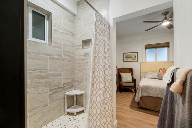 bathroom with hardwood / wood-style flooring, ceiling fan, and a shower with curtain