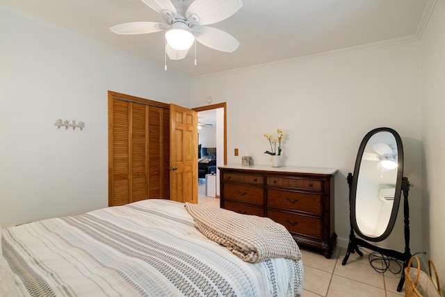 bedroom featuring crown molding, light tile patterned floors, ceiling fan, and a closet