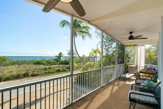 balcony with a water view and ceiling fan