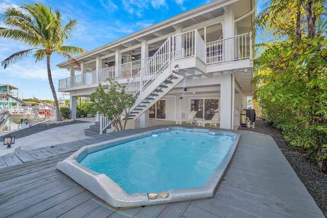 218 Bristol Ct, Tavernier, FL 33070 - swimming pool with stairway, ceiling fan, a wooden deck, and a patio area