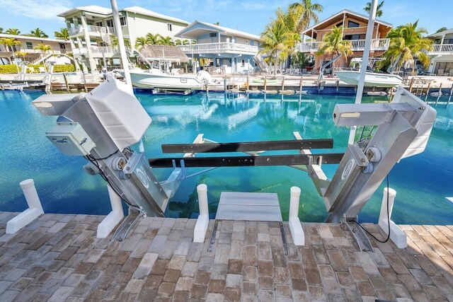 218 Bristol Ct, Tavernier, FL 33070 - view of swimming pool with boat lift, a boat dock, and a water view
