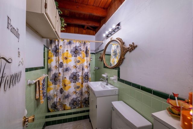 bathroom featuring beamed ceiling, tile walls, vanity, toilet, and a shower with shower curtain