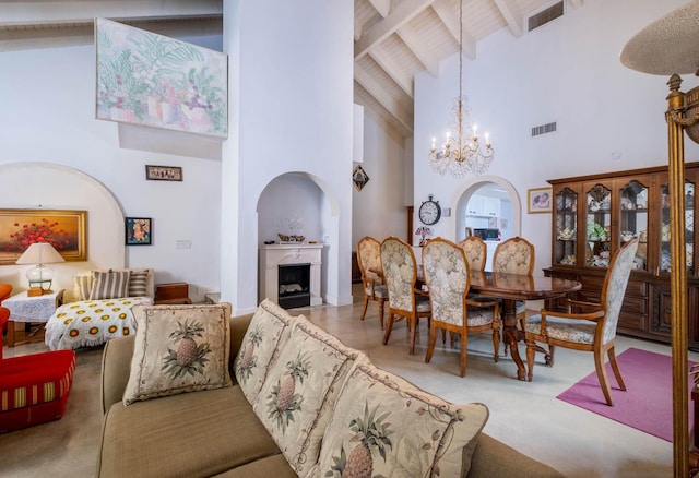 dining room with a notable chandelier, high vaulted ceiling, and beamed ceiling