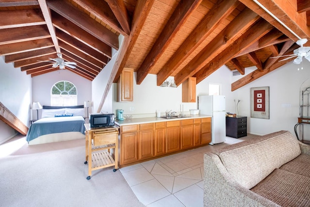 kitchen featuring lofted ceiling with beams, sink, white fridge, light tile patterned floors, and ceiling fan