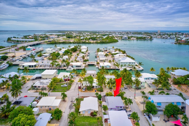 drone / aerial view with a residential view and a water view