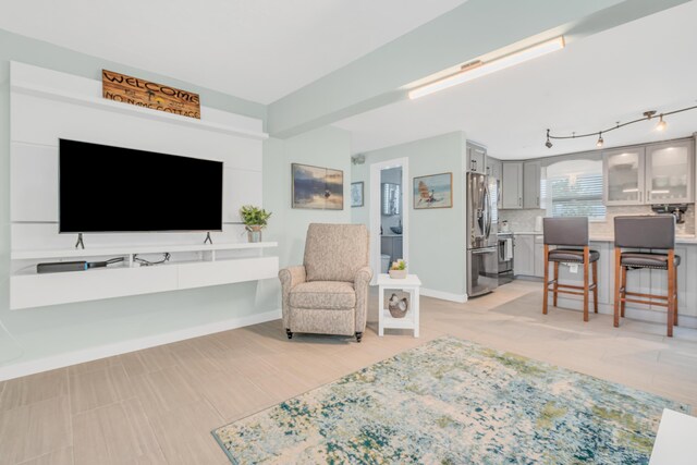 living area featuring baseboards