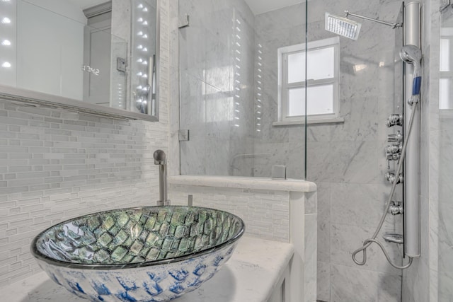 full bathroom with a sink and tiled shower