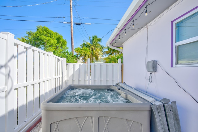 exterior space with fence private yard and a hot tub