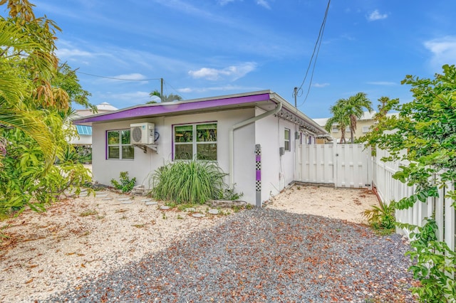 view of front of house with fence and stucco siding