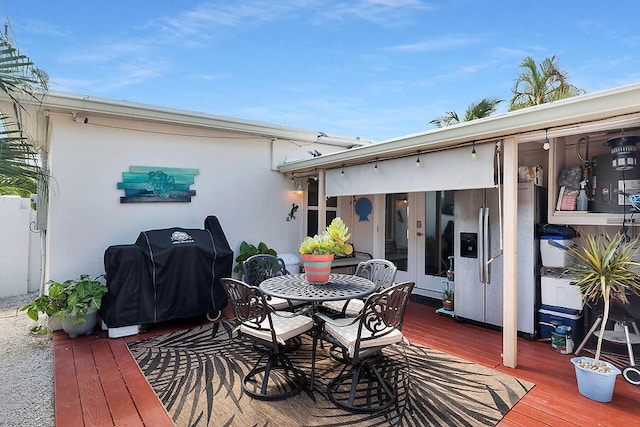 wooden deck with area for grilling and french doors