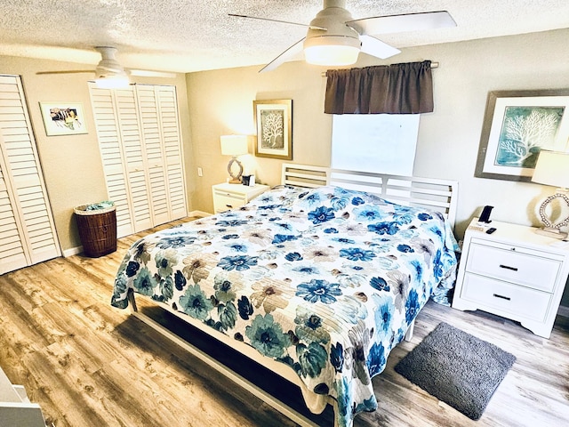 bedroom with ceiling fan, a textured ceiling, and light wood-type flooring