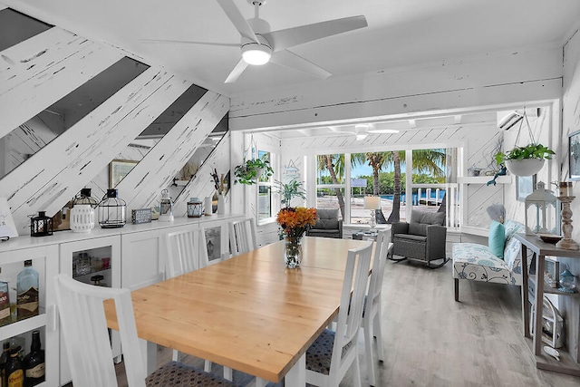 dining area with ceiling fan and light hardwood / wood-style floors