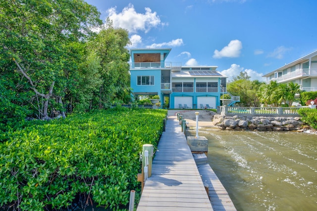 dock area with a balcony and fence